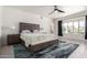 Bright main bedroom with ceiling fan, large bed, bay window, and stylish area rug at 1834 E Willow Tree Ct, Gilbert, AZ 85234