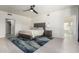Spacious bedroom featuring a large bed, ceiling fan, and access to the en suite bath at 1834 E Willow Tree Ct, Gilbert, AZ 85234