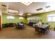 Clubhouse meeting room with tables, chairs, sofas, and decorative wall mural at 1834 E Willow Tree Ct, Gilbert, AZ 85234