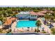 Aerial view of a community pool with lounge chairs and palm trees, offering a resort-like experience at 1834 E Willow Tree Ct, Gilbert, AZ 85234