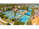 Aerial view of many tennis courts with mature palm trees at 1834 E Willow Tree Ct, Gilbert, AZ 85234