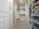 Organized walk-in closet with custom shelving, drawers, and ample storage space at 1834 E Willow Tree Ct, Gilbert, AZ 85234