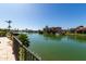Beautiful waterfront property with lush landscaping and serene lake views at 1834 E Willow Tree Ct, Gilbert, AZ 85234