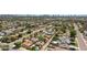 Extensive aerial view of a neighborhood featuring lush greenery, streets, and swimming pools, with the cityscape in the distance at 1940 E Indianola E Ave, Phoenix, AZ 85016