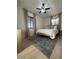Bright bedroom features neutral decor, stylish area rug, ceiling fan, and a comfortable bed at 1940 E Indianola E Ave, Phoenix, AZ 85016