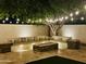 Inviting backyard with an outdoor fire pit, built-in seating, and string lights perfect for entertaining at 1953 W Lark Dr, Chandler, AZ 85286