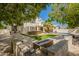 Lush backyard with an outdoor kitchen, patio, grassy area, and a refreshing pool at 1953 W Lark Dr, Chandler, AZ 85286