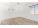 White bedroom features wood-look floors, a ceiling fan, and multiple windows at 1953 W Lark Dr, Chandler, AZ 85286