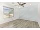 Bright bedroom features wood-look floors, ceiling fan, and large window at 1953 W Lark Dr, Chandler, AZ 85286
