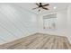 Bright bedroom features wood-look floors, modern ceiling fan, and stylish decorative wall at 1953 W Lark Dr, Chandler, AZ 85286