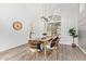 Dining room featuring a wood table, wicker chairs, modern light fixture, and large window at 1953 W Lark Dr, Chandler, AZ 85286