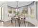 Bright dining area features a modern chandelier and large windows with views of the outdoor patio at 1953 W Lark Dr, Chandler, AZ 85286
