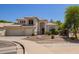 Attractive front exterior showcases desert landscaping, a three-car garage, and timeless architecture at 1953 W Lark Dr, Chandler, AZ 85286
