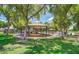 Community park featuring a shaded playground, picnic tables, and benches surrounded by lush green lawns at 1953 W Lark Dr, Chandler, AZ 85286