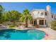 Beautiful backyard with a pool, palm tree, patio, and outdoor seating area at 1953 W Lark Dr, Chandler, AZ 85286