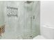 Contemporary glass-enclosed shower with pebble floor and bench seating at 1953 W Lark Dr, Chandler, AZ 85286