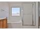 Bright bathroom featuring a soaking tub, glass shower, and a view to the outside at 21141 N 79Th Ave, Peoria, AZ 85382