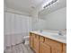 Bright bathroom featuring a double sink vanity, large mirror, and a shower-tub combination with modern fixtures at 21141 N 79Th Ave, Peoria, AZ 85382