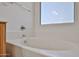 Close-up on bathtub in the bathroom with shower and outside window at 21141 N 79Th Ave, Peoria, AZ 85382
