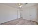 Bright bedroom featuring wood-look floors, white walls, and ample closet space at 21141 N 79Th Ave, Peoria, AZ 85382