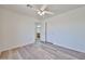 Spacious bedroom with wood-look floors, ceiling fan, closet, and en suite bathroom at 21141 N 79Th Ave, Peoria, AZ 85382