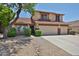 Charming two-story home featuring a three-car garage and well-maintained desert landscaping at 21141 N 79Th Ave, Peoria, AZ 85382