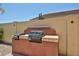 Built-in outdoor grill area featuring a modern grill on a tiled counter at 21141 N 79Th Ave, Peoria, AZ 85382