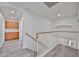 Bright hallway featuring a staircase with wood railing and a view of built-in wooden cabinets at 21141 N 79Th Ave, Peoria, AZ 85382