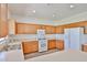 Bright kitchen featuring white appliances, light countertops, and ample wood cabinetry at 21141 N 79Th Ave, Peoria, AZ 85382