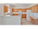 Bright kitchen featuring white appliances, light countertops, and ample wood cabinetry at 21141 N 79Th Ave, Peoria, AZ 85382