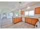Bright open kitchen area featuring generous wood cabinetry, white appliances and neutral countertops at 21141 N 79Th Ave, Peoria, AZ 85382