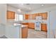 Well-lit kitchen featuring white appliances, light countertops, and ample wood cabinetry at 21141 N 79Th Ave, Peoria, AZ 85382