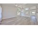 Bright, open-concept living room with arched windows, wood floors, and modern ceiling fan at 21141 N 79Th Ave, Peoria, AZ 85382