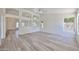 Bright, open-concept living room featuring modern light fixtures and beautiful wood floors at 21141 N 79Th Ave, Peoria, AZ 85382