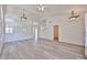 Bright, open-concept living room with arched windows, wood floors, and modern ceiling fan at 21141 N 79Th Ave, Peoria, AZ 85382
