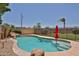 Beautiful outdoor pool features rock accents, beach entry, and a safety fence for added peace of mind at 21141 N 79Th Ave, Peoria, AZ 85382