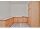 Spacious storage room with abundant light wood cabinets and drawers for ample storage at 21141 N 79Th Ave, Peoria, AZ 85382