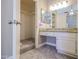 Bathroom featuring a granite vanity, storage, and access to a walk-in closet at 2301 E University Dr # 210, Mesa, AZ 85213