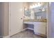 Bathroom vanity with granite countertop, storage cabinets, and lighted mirror at 2301 E University Dr # 210, Mesa, AZ 85213