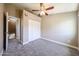 Cozy bedroom with a closet, neutral paint and carpet flooring, and a ceiling fan at 2301 E University Dr # 210, Mesa, AZ 85213