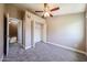 Bedroom featuring a ceiling fan and closet and carpet flooring at 2301 E University Dr # 210, Mesa, AZ 85213