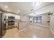 A kitchen with stainless steel appliances and granite countertops opens to a living room at 2301 E University Dr # 210, Mesa, AZ 85213