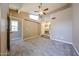 Main bedroom featuring carpeted floors, large windows, and ensuite bathroom at 2301 E University Dr # 210, Mesa, AZ 85213