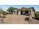 The backyard offers a covered patio, desert landscaping, decorative pavers and a fire pit at 23075 W Arrow Dr, Buckeye, AZ 85326