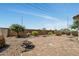 The backyard patio features decorative pavers, desert landscaping and a cozy fire pit at 23075 W Arrow Dr, Buckeye, AZ 85326