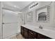 Bright bathroom features a shower, decorative mirrors, and ample counter space at 23075 W Arrow Dr, Buckeye, AZ 85326