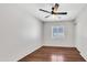 Bedroom featuring laminate flooring, a ceiling fan, a window, and white walls at 23075 W Arrow Dr, Buckeye, AZ 85326