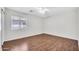 Bright bedroom showcases hardwood floors, a window with blinds, and ample space for furniture at 23075 W Arrow Dr, Buckeye, AZ 85326