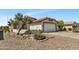 Desert home showcasing low-maintenance landscaping, tiled roof, and stucco facade at 23075 W Arrow Dr, Buckeye, AZ 85326