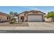 Charming single-story home featuring a two-car garage, terracotta tile roof, and desert landscaping at 23075 W Arrow Dr, Buckeye, AZ 85326
